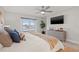 Relaxing main bedroom features a water view, sliding glass doors, and a ceiling fan at 3961 12Th Ne St, St Petersburg, FL 33703