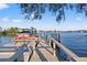 Waterfront dock featuring a boat lift and kayak storage for easy access to the water at 3961 12Th Ne St, St Petersburg, FL 33703