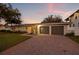 The two-car garage is in front of a well-maintained front lawn and a brick-paved driveway at 3961 12Th Ne St, St Petersburg, FL 33703