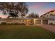 Charming single-story home featuring a manicured lawn, mature trees, and a two-car garage at 3961 12Th Ne St, St Petersburg, FL 33703