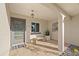 A welcoming front porch features a modern door, ambient lighting, and decorative potted plants at 3961 12Th Ne St, St Petersburg, FL 33703