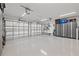 Spacious garage with epoxy flooring, storage cabinets, and overhead lighting at 3961 12Th Ne St, St Petersburg, FL 33703
