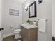 Stylish powder room with sleek vanity, square mirror, and modern lighting at 3961 12Th Ne St, St Petersburg, FL 33703