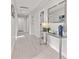 Bright hallway with tile floors and a modern console table with mirror creates an inviting entryway at 3961 12Th Ne St, St Petersburg, FL 33703