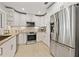 Spacious kitchen featuring stainless steel appliances and modern white cabinetry at 3961 12Th Ne St, St Petersburg, FL 33703