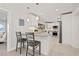 Bright white kitchen with bar seating, stainless appliances, and mosaic tile backsplash at 3961 12Th Ne St, St Petersburg, FL 33703
