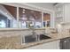 Kitchen sink with view of the outside covered patio with ceiling fan and waterfront beyond at 3961 12Th Ne St, St Petersburg, FL 33703