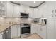Well-lit kitchen with stainless steel appliances, and granite countertops at 3961 12Th Ne St, St Petersburg, FL 33703