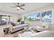 A bright living room with light-colored furniture and a large window with scenic waterfront views at 3961 12Th Ne St, St Petersburg, FL 33703