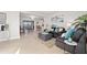 Open-concept living room with comfortable seating, lots of natural light, and a view of the dining area at 3961 12Th Ne St, St Petersburg, FL 33703