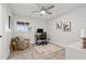 Bright home office with modern ceiling fan, neutral walls, desk, chair, and rug at 3961 12Th Ne St, St Petersburg, FL 33703