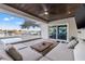 Inviting outdoor patio with comfortable seating, pool, and waterfront view at 3961 12Th Ne St, St Petersburg, FL 33703