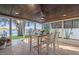 Inviting covered patio featuring stone floors, ceiling fan, and waterfront views at 3961 12Th Ne St, St Petersburg, FL 33703