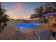 Backyard pool and patio area with lounge seating and waterfront views at sunset at 3961 12Th Ne St, St Petersburg, FL 33703
