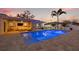 Backyard pool and patio area with outdoor seating and waterfront views at sunset at 3961 12Th Ne St, St Petersburg, FL 33703