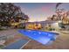 Backyard pool and outdoor patio area with lounge seating and waterfront views at sunset at 3961 12Th Ne St, St Petersburg, FL 33703