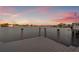 Waterfront view from the private dock with boat lift and sunset colors at 3961 12Th Ne St, St Petersburg, FL 33703