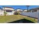 View of backyard that has a partial shadow from the house, a lawn and fence at 4017 W Nassau St, Tampa, FL 33607