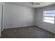 Cozy carpeted bedroom featuring a ceiling fan and a window that provides lots of natural light at 4017 W Nassau St, Tampa, FL 33607