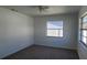 This bedroom has carpet, light coming in from the windows, and neutral paint at 4017 W Nassau St, Tampa, FL 33607