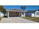 Cozy single-story home featuring a covered carport and a freshly paved driveway at 4017 W Nassau St, Tampa, FL 33607