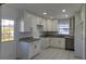 Modern kitchen with white cabinets, granite countertops, stainless steel appliances and bright lighting at 4017 W Nassau St, Tampa, FL 33607