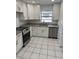 Bright kitchen featuring stainless steel appliances, granite countertops and white cabinets at 4017 W Nassau St, Tampa, FL 33607