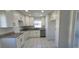 Updated kitchen with white cabinets, granite countertops, stainless steel appliances and tile flooring at 4017 W Nassau St, Tampa, FL 33607