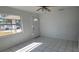 Bright living room featuring tile floors, a ceiling fan, and a front door with decorative window at 4017 W Nassau St, Tampa, FL 33607