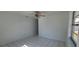 Minimalist room design with bright, white walls, a ceiling fan and tile floors at 4017 W Nassau St, Tampa, FL 33607