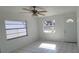 Bright living room with white-painted walls, tile floors, a ceiling fan and natural light at 4017 W Nassau St, Tampa, FL 33607
