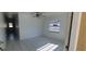 A minimalist room featuring white walls, a ceiling fan, tile floors and natural light at 4017 W Nassau St, Tampa, FL 33607