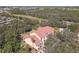 Aerial shot of a condo building featuring red clay tile roof and mature trees at 4106 Central Sarasota Pkwy # 1023, Sarasota, FL 34238
