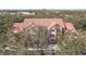 Aerial shot of a multi-Gathering building with a clay tile roof surrounded by trees at 4106 Central Sarasota Pkwy # 1023, Sarasota, FL 34238