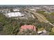 Stunning aerial view of a red-roofed condominium complex surrounded by lush greenery and a shopping center nearby at 4106 Central Sarasota Pkwy # 1023, Sarasota, FL 34238