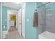 Well-lit bathroom featuring tiled shower, and access to the laundry room at 4106 Central Sarasota Pkwy # 1023, Sarasota, FL 34238