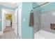 Bathroom featuring tiled shower, and view to the laundry room at 4106 Central Sarasota Pkwy # 1023, Sarasota, FL 34238
