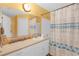 Bathroom featuring a large vanity with storage and a shower with curtain at 4106 Central Sarasota Pkwy # 1023, Sarasota, FL 34238