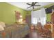 This bedroom features wood floors, a ceiling fan, and a desk area at 4106 Central Sarasota Pkwy # 1023, Sarasota, FL 34238