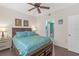 Comfortable bedroom with a decorative ceiling fan and view to the en-suite bathroom at 4106 Central Sarasota Pkwy # 1023, Sarasota, FL 34238