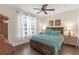 Comfortable bedroom with a decorative ceiling fan and natural light at 4106 Central Sarasota Pkwy # 1023, Sarasota, FL 34238