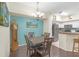 Open dining area with dark wood floors, adjacent to the kitchen, creating a cohesive living space at 4106 Central Sarasota Pkwy # 1023, Sarasota, FL 34238