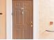 Close-up of a unit's exterior front door with visible unit number and hardware at 4106 Central Sarasota Pkwy # 1023, Sarasota, FL 34238