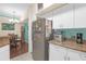 Functional kitchen area with stainless steel refrigerator and adjacent dining space at 4106 Central Sarasota Pkwy # 1023, Sarasota, FL 34238