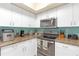 Efficiently designed kitchen with white cabinets, stainless appliances, and ample counter space at 4106 Central Sarasota Pkwy # 1023, Sarasota, FL 34238