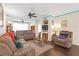 Relaxing living room featuring comfortable seating, a ceiling fan and a mounted television at 4106 Central Sarasota Pkwy # 1023, Sarasota, FL 34238