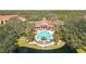 Beautiful aerial view of a community pool, complemented by palm trees and tranquil pond at 4106 Central Sarasota Pkwy # 1023, Sarasota, FL 34238