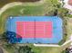 Aerial view of a well-maintained tennis court surrounded by lush greenery, perfect for recreation at 4106 Central Sarasota Pkwy # 1023, Sarasota, FL 34238