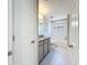 Modern bathroom featuring a tub, gray cabinets, granite counters, and tile floors at 4132 Woods Rider Loop, Odessa, FL 33556