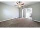 Neutral bedroom with carpet floors and arched entrance way to the foyer at 4132 Woods Rider Loop, Odessa, FL 33556
